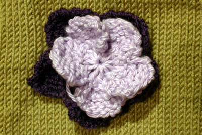 Debbie Bliss Jacket With Moss Stitch Bands - flower close up